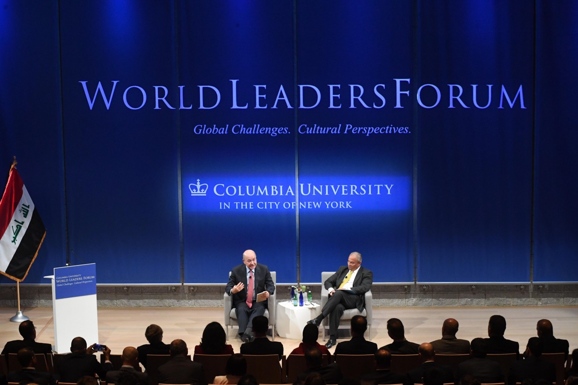 A World Leaders Forum event with the President of Iraq speaking to guests from the stage in the Bollinger Forum's Auditorium