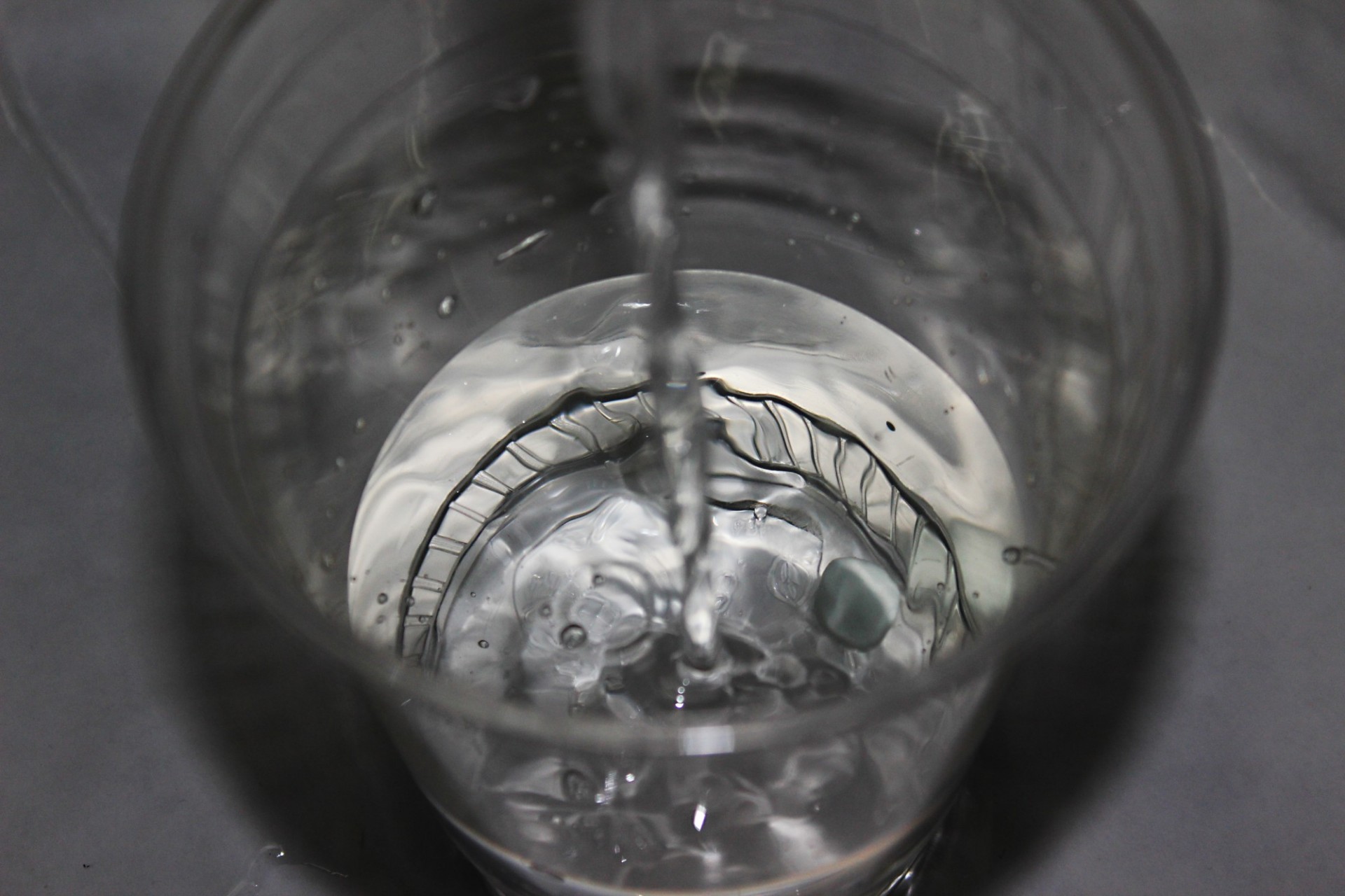 Bird's eye view of a plastic cup of water being filled
