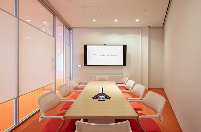 Room 317 features a conference table with ten chairs and a mounted digital screen