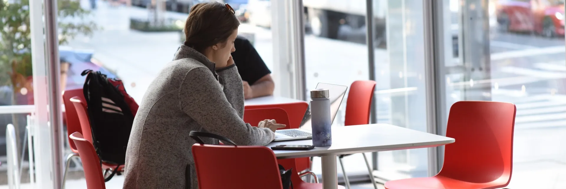 Person sitting at a cafe table 