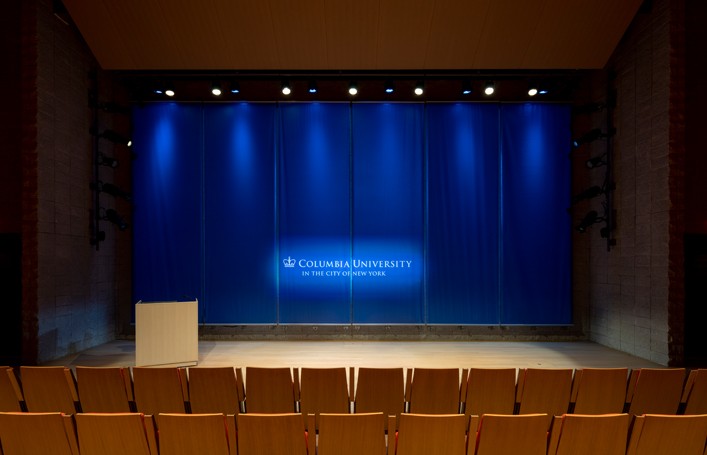Auditorium Front view of the Auditorium stage with no setup and screen is up
