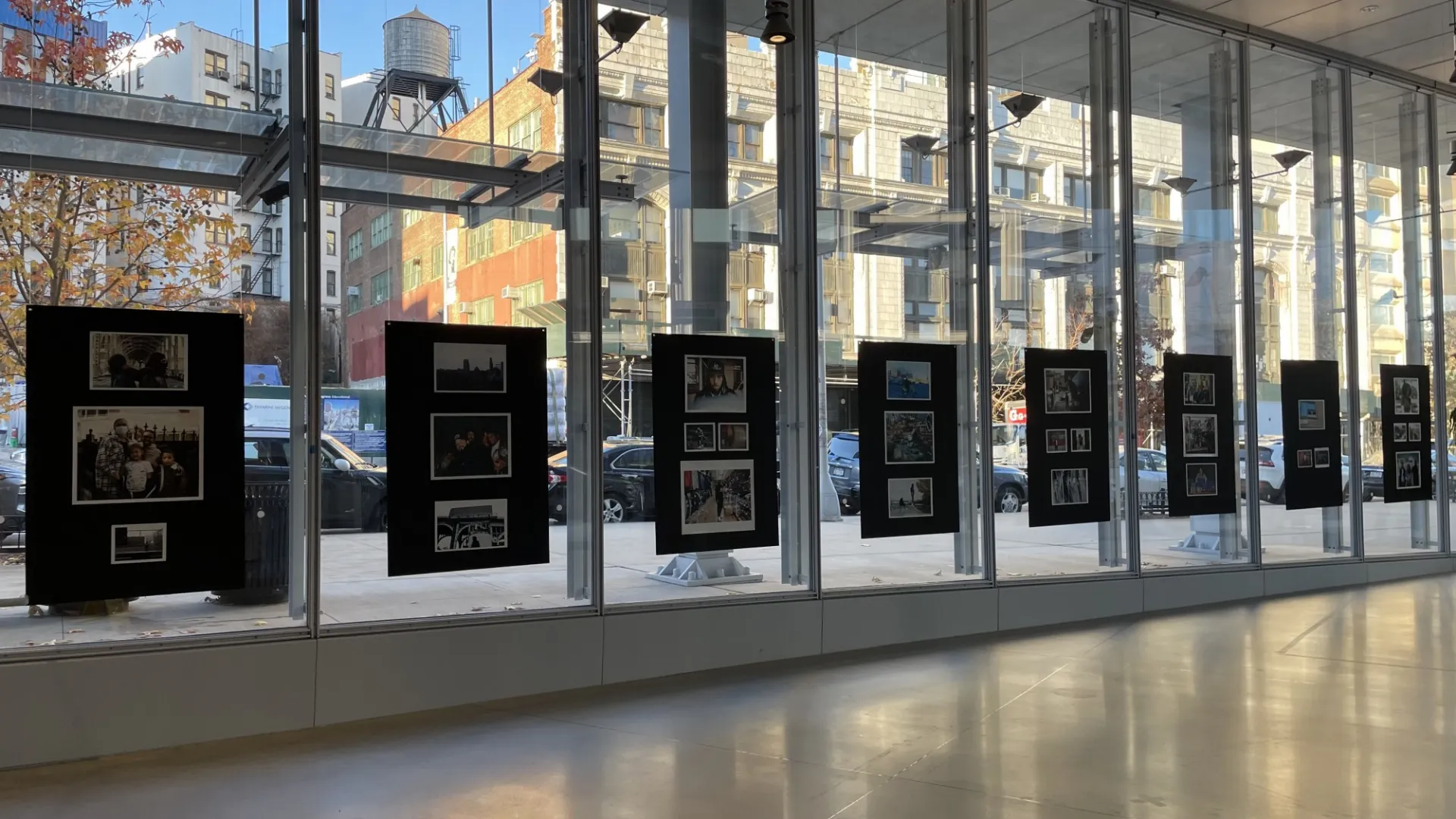 Eight large black photo boards displayed vertically in the windows of The Forum's west Atrium