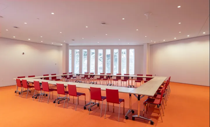 The Forum's Foyer room with tables and chairs setup in a hollow square formation