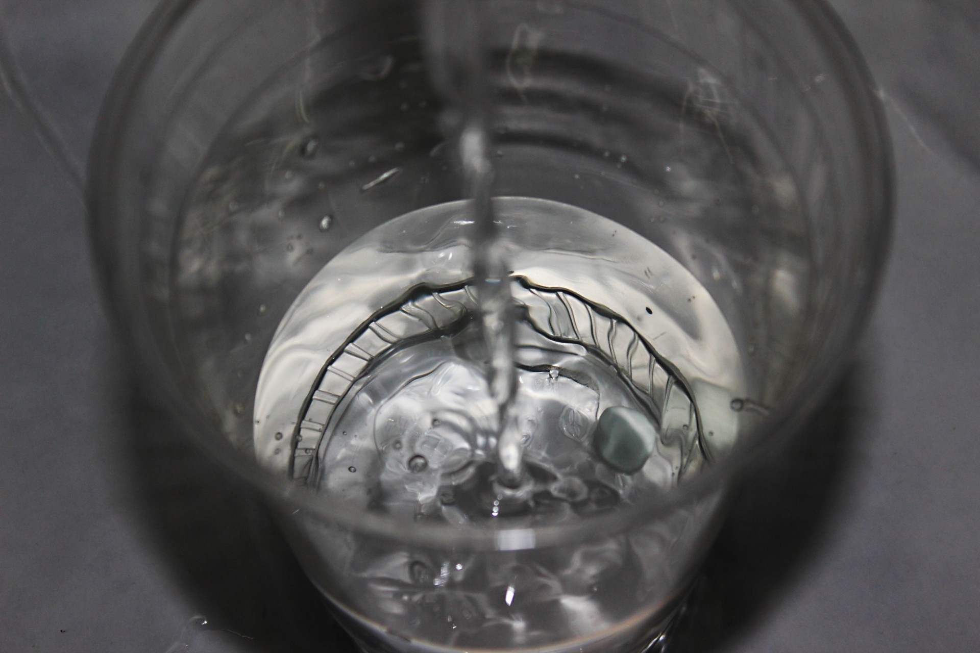 Photograph by Nevea Bird's eye view of a plastic cup of water being filled